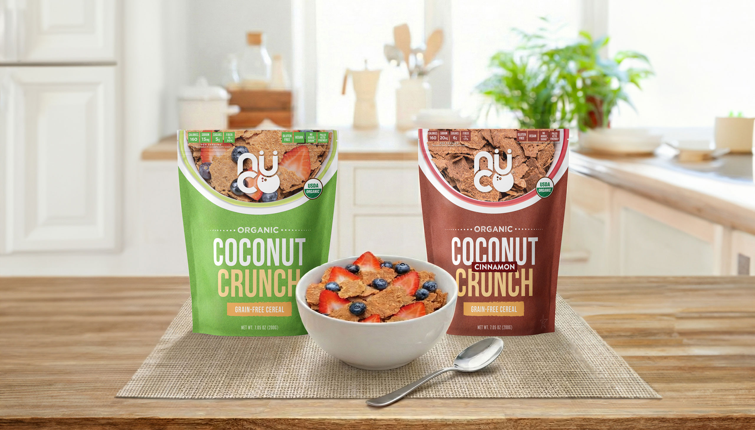 Two Coconut Crunch pouches and a bowl of cereal on a wooden counter